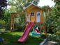 Mobile Preview: Stelzenhaus Jonas L-A1 aus Holz Kinderspielhaus Baumhaus fuer Kinder mit Wellenrutsche